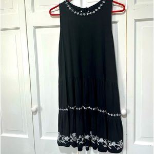 Black swing dress with tie back and white detailing.